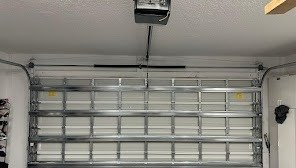 Steel sectional garage door with the opener rail and motor mounted on the ceiling